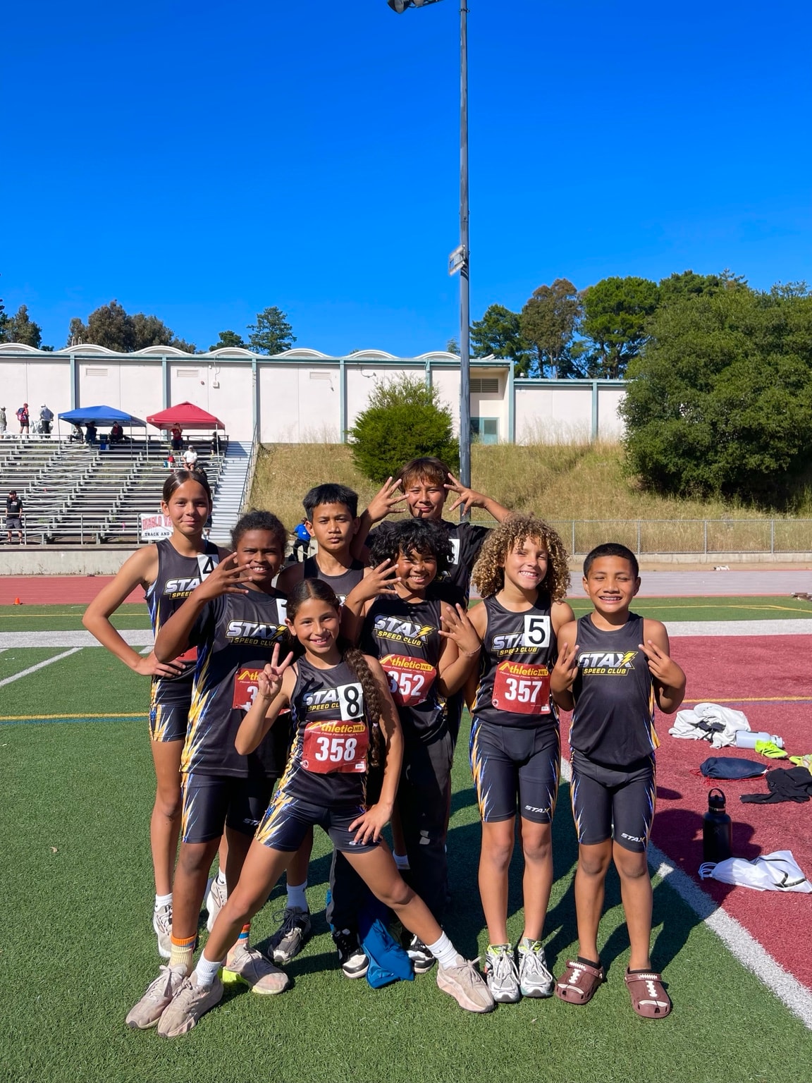 STAX athletes at a track meet with race bibs